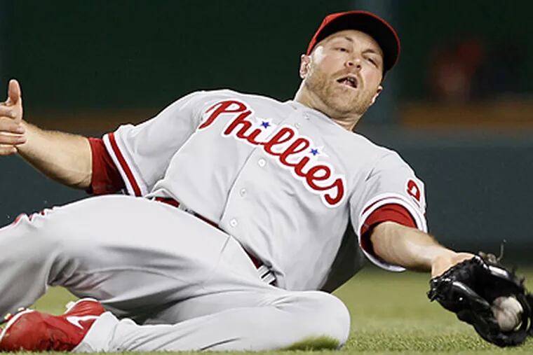 New Phillies right fielder Nate Schierholtz slides to catch a ball in a 3-2 win over the Nationals. (AP Photo/Carolyn Kaster)