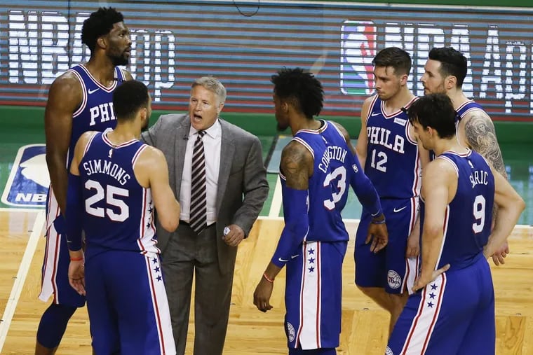 Sixers coach Brett Brown gathers his team to discuss a play late in the fourth-quarter against the Boston Celtics in game five of the Eastern Conference semifinals on Wednesday, May 9, 2018 in Boston.