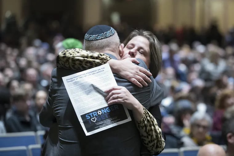 Members of crowd at Soldiers & Sailors Memorial Hall hug while attending a memorial service for the 11 people killed at Tree of Life synagogue Pittsburgh on Oct. 28, 2018.