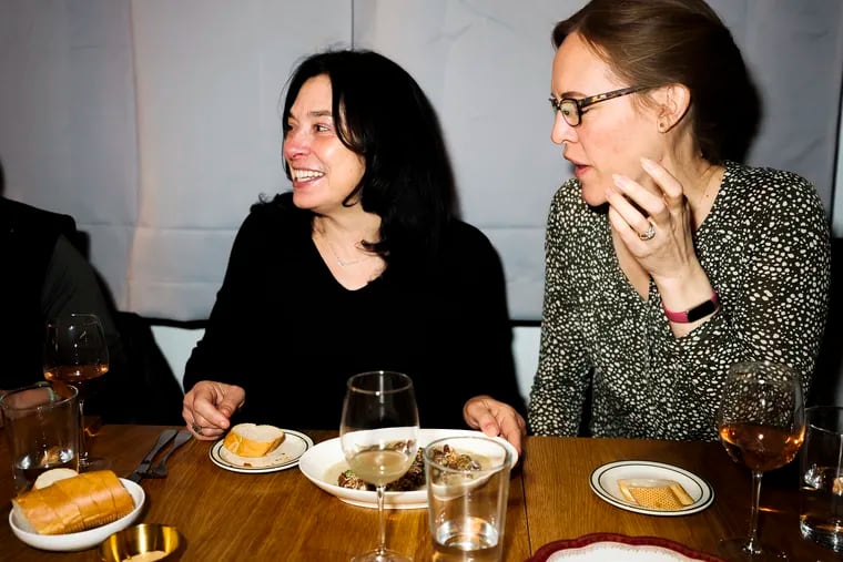 Sharon Thompson-Schill, left, dines out with friends, including best friend and fellow neuroscientist Anna Jenkins, right.