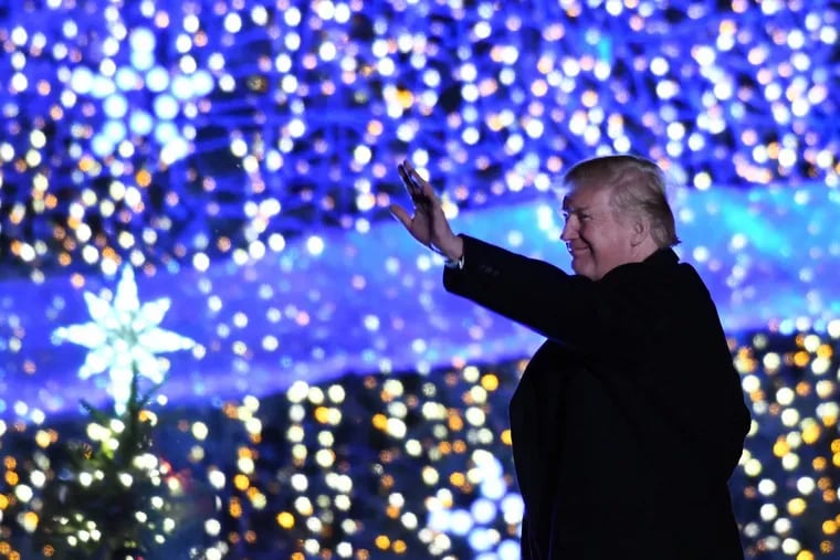 President Trump waves during the National Christmas Tree lighting ceremony on Thursday in Washington.