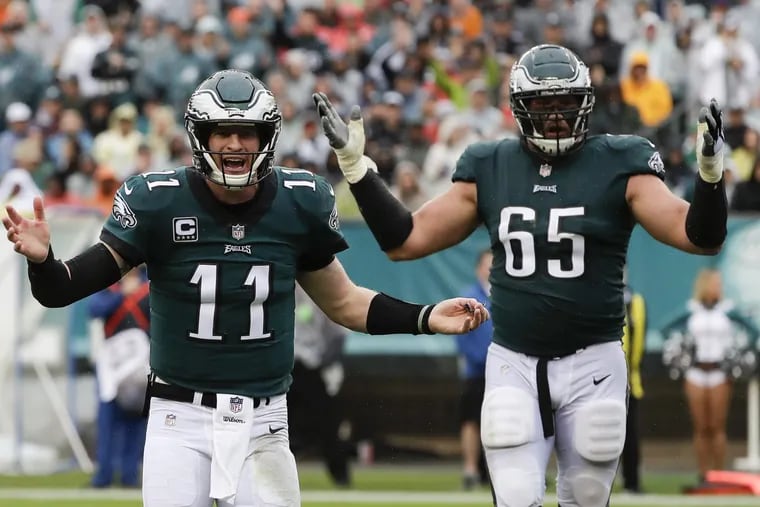 Eagles quarterback Carson Wentz responds to a non-pass interference penalty call with teammate offensive tackle Lane Johnson against the Indianapolis Colts on Sunday, September 23, 2018 in Philadelphia. YONG KIM / Staff Photographer