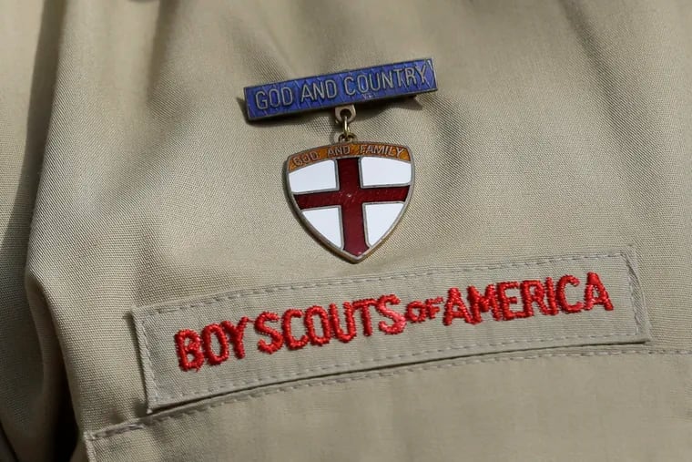 FILE - In this Feb. 4, 2013 file photo, shows a close up detail of a Boy Scout uniform worn during a news conference in front of the Boy Scouts of America headquarters in Irving, Texas.  The Boy Scouts of America says it is exploring "all options" to address serious financial challenges, but is declining to confirm or deny a report that it may seek bankruptcy protection in the face of declining membership and sex-abuse litigation.  "I want to assure you that our daily mission will continue and that there are no imminent actions or immediate decisions expected," Chief Scout Executive Mike Surbaugh said in a statement issued Wednesday, Dec. 12, 2018.    (AP Photo/Tony Gutierrez, File)