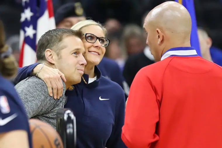 Indiana Pacers assistant coach Jenny Boucek hugging 76ers assistant coach Dave Joerger, left, while they spoke with an official before a game April 9.