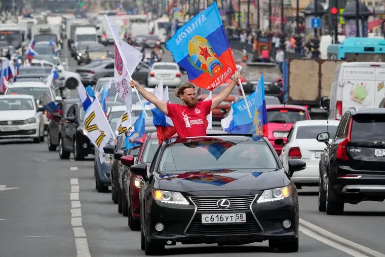 Members of a pro-Kremlin youth organization ride in cars with flags of Luhansk People Republic along the central avenue of St. Petersburg, Russia, as they celebrated full control over Luhansk Region, announced by Russian authorities, on Tuesday.
