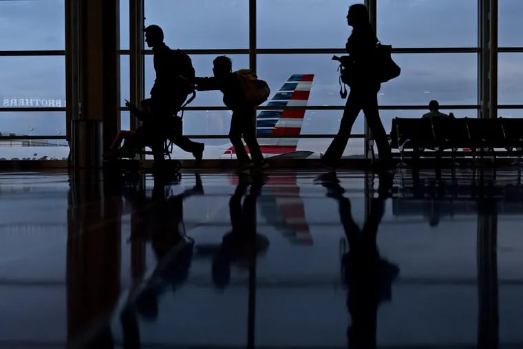 Travelers walk through Ronald Reagan National Airport (DCA) in Washington, D.C.
