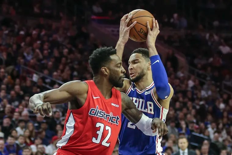 Ben Simmons grabs a pass behind the Wizards' Jeff Green during the second quarter.
