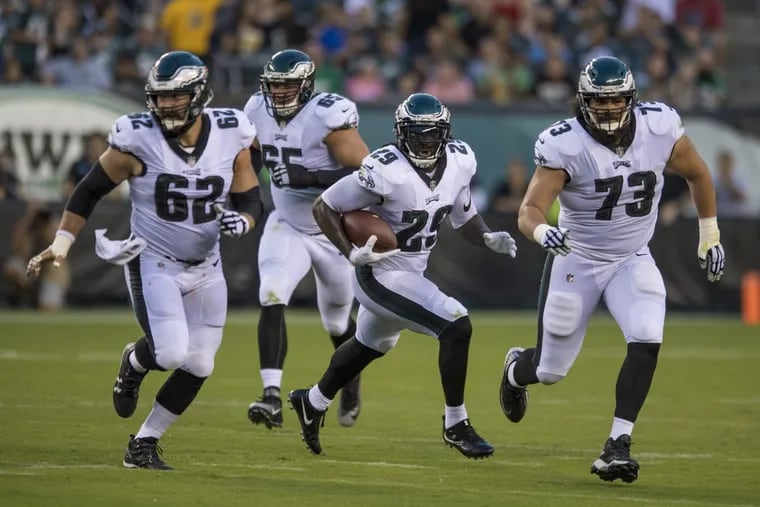 New Eagles running back LeGarrette Blount runs upfield with a reception following the blocks of Jason Kelce (left) and Isaac Seumalo (right) — with Lane Johnson bringing up the rear — in the 1st quarter as the Bills play the Eagles at Lincoln Financial Field August 17.