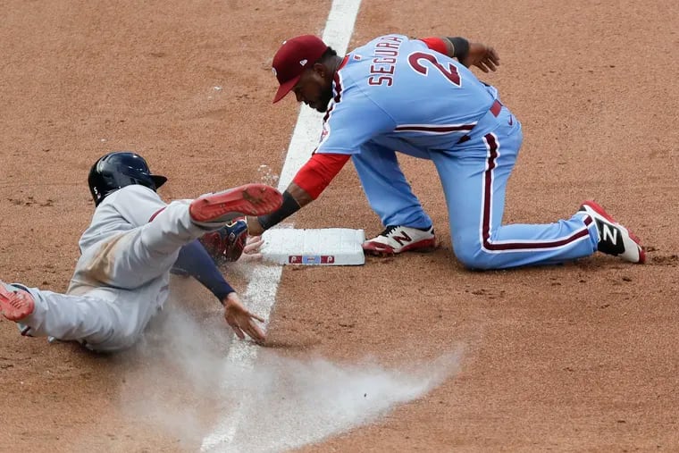 Phillies third baseman Jean Segura tags out Atlanta Braves  Freddie Freeman at third in the ninth inning during game one doubleheader on Sunday, August 9, 2020. Comcast will give customers credits for MLB games that weren’t played during the second quarter this year.