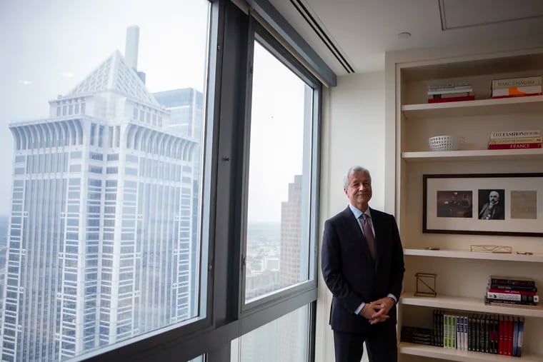 Jamie Dimon, head of JPMorgan Chase & Co., the largest and most profitable U.S. bank, stands at its Center City outpost near the top of One Liberty Place, Wednesday, June 05, 2019. Behind Dimon, among other towers, is the headquarters of Comcast, the largest Philadelphia-based company and a longtime JPMorgan client whose CFO, Michael J. Cavanaugh, formerly held the same post at Dimon's bank.