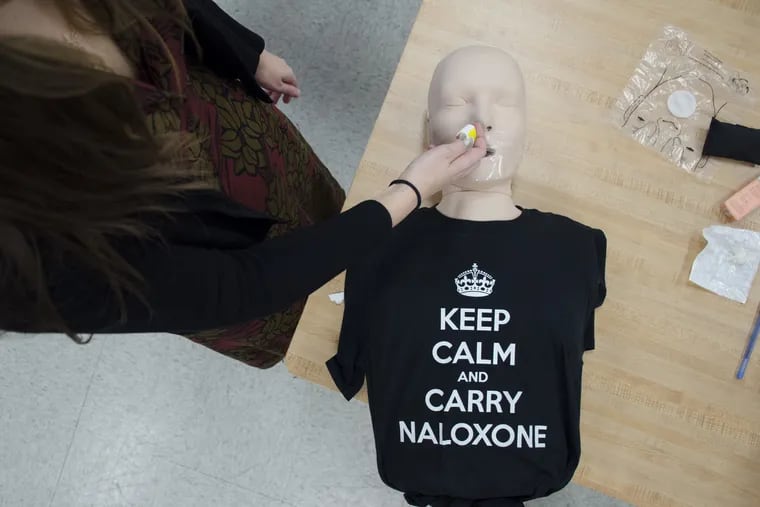 Harm Reduction Coordinator Allison Herens administers a Narcan nasal spray to a test dummy during an opioid public awareness campaign at the Philadelphia Department of Public Health in Center City in March.