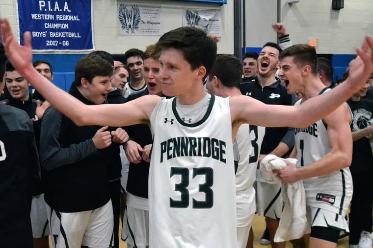 Pennridge’s Jack Gillespie ,33, and his Ram teammates celebrate after defeating LaSalle 52-47 in their PIAA Class 6A Semifinal playoff contest at Norristown High School on Tuesday March 19,2019. MARK C PSORAS/For the Inquirer