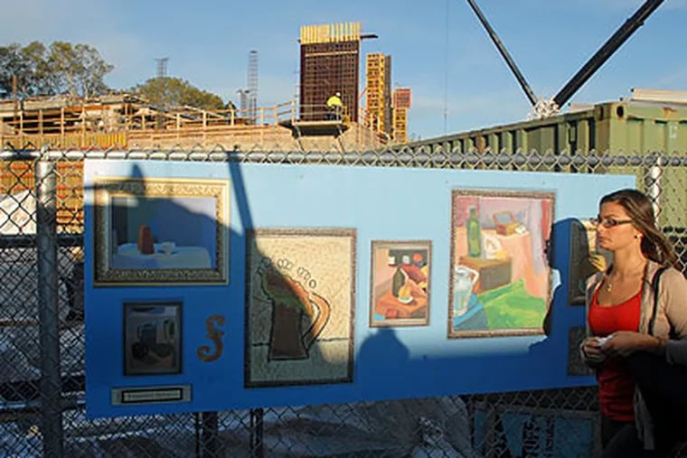 Art by students from Friends Select School, created in the style of the artists whose works are part of the Barnes' collection, adorn the construction fence along 20th Street on Friday as work continues on the collection's new home. (Tom Gralish / Staff Photographer)