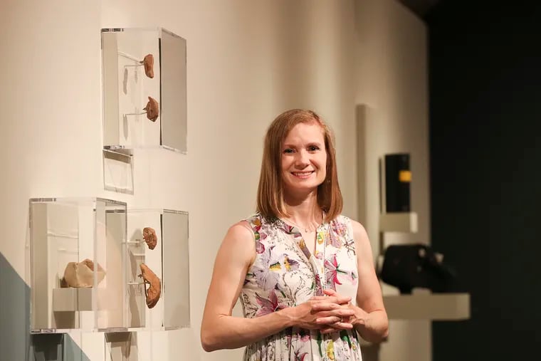 Penn anthropologist Emily Hammer stands in the exhibit space that will display U-2 spy plane photos from the late 1950s at the Penn Museum. The exhibition, curated by Hammer, explores what Cold War aerial photography reveals about Mesopotamia and the Middle East.