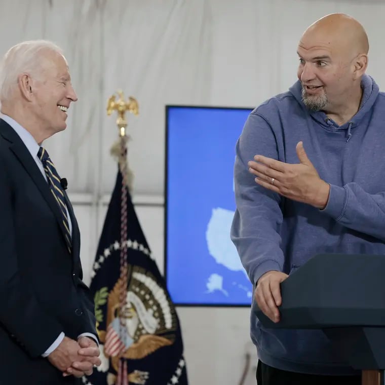 Sen. John Fetterman, D-Pa., (right) makes President Joe Biden laugh during a 2023 news conference. The Democratic senator this week criticized the president's threat to withhold some arms supplies to Israel.