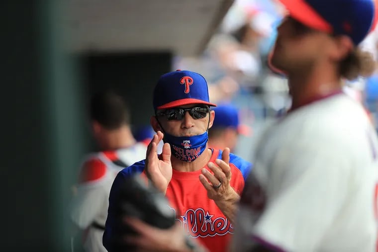 Manager Joe Girardi applauding as starting pitcher Aaron Nola returned to the dugout in the fifth inning when the Phillies played the New York Yankees on June 13.