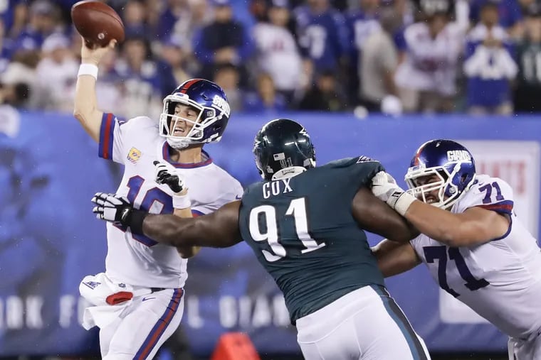 Eagles defensive tackle Fletcher Cox goes after New York Giants quarterback Eli Manning against offensive guard Will Hernandez during the second-quarter on Thursday, October 11, 2018 in East Rutherford, NJ. YONG KIM / Staff Photographer