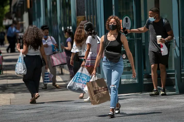 Shoppers outside Liberty Place in Center City Philadelphia wear face masks on Monday.