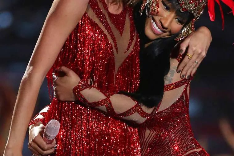Taylor Swift (left) and Nicki Minaj &quot;make up&quot; at the &quot;VMAs&quot; Sunday after a feud on Twitter.