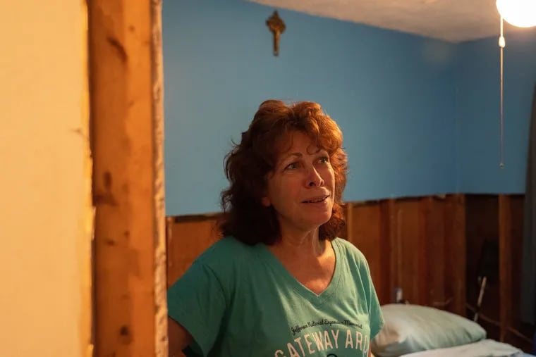 Denise Lees in her bedroom on Lenape trail in August after damaged drywall was removed, leaving the framing of the house exposed after June flooding in Southampton.