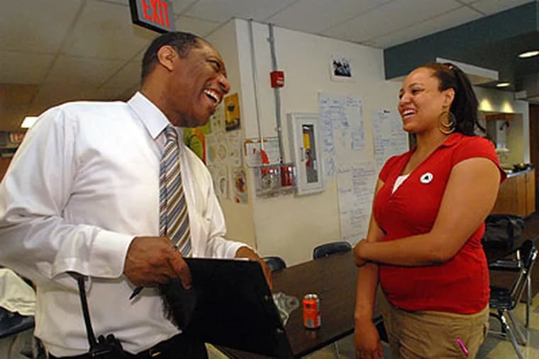 Acting South Philadelphia High School Principal Ozzie Wright chats with student Latisha Martin, 18, last month. Wright was named principal of West Philadelphia High School on Friday. (April Saul / Staff Photographer)