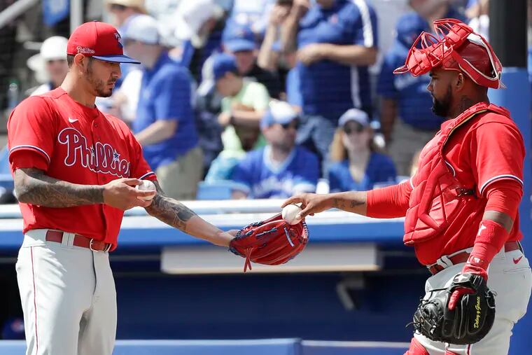 Phillies pitcher Vince Velasquez gets a new baseball from catch Deivy Grullon after Blue Jays Travis Shaw hit a two run home run.