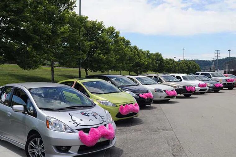 Lyft cars, with their trademark pink mustaches, ready for a parade in Western Pennsylvania. Lyft began operation around 6:30 p.m. Friday in Philly. (Connor Mulvaney/Pittsburgh Post-Gazette/TNS)