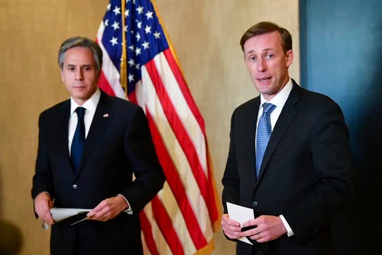 Secretary of State Antony Blinken (left) listens as national security adviser Jake Sullivan (right) talks to the media after a closed-door morning session of U.S.-China talks in Anchorage, Alaska, on Friday, March 19, 2021.