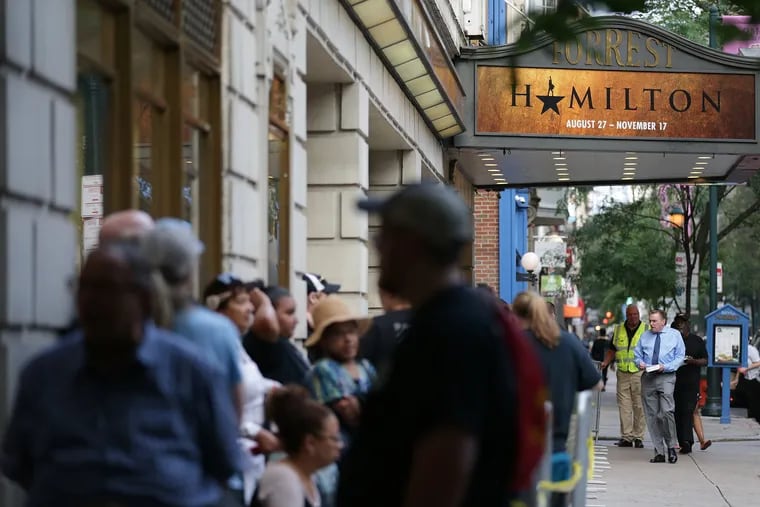 Fans wait in line to get wristbands that might give them an opportunity to buy tickets for the musical "Hamilton" at the Forrest Theatre in Philadelphia, PA on July 9, 2019