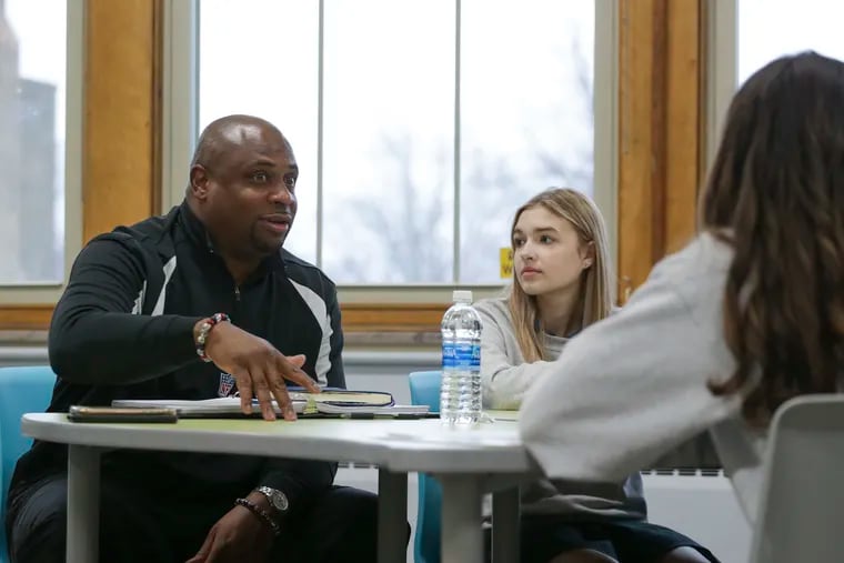 Troy Vincent Sr., executive vice president of football operations for the NFL, speaks with Kaylee Cuddihy and other members of the "Flag Football United" initiative on Wednesday, Jan. 18, 2023, in Kenmore, N.Y.