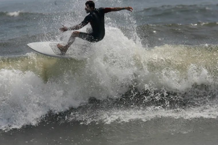 Hurricane Earl isn't stopping local surfers from riding the waves. The storm isn't expected to ruin the holiday weekend at the shore. (Michael S. Wirtz / Staff Photographer)
