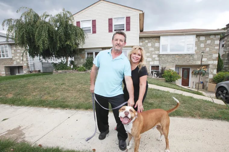 Christos, left, and Markela Sourovelis in front of their Northeast Philadelphia home with their pit bull, Max, on Tuesday, September 16, 2014. ( Steven M. Falk / Staff Photographer )