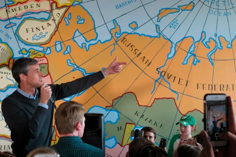 Democratic presidential candidate Beto O'Rourke speaks to supporters at a coffee shop on Sunday, March 17, 2019, in Madison, Wisconsin. O'Rourke came in wearing a green cabbage St. Patrick's Day necklace given to him by a supporter during breakfast. (AP Photo/Scott Bauer)