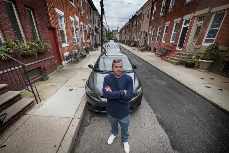 Matt Allen near his car on Sept. 7 in South Philadelphia. After his car was moved from a legal spot to an illegal one, it got ticketed. He said he had to pay about $400. The city is offering him $15,000 for his "courtesy" tow troubles.