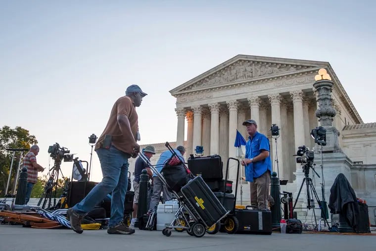 News crews set up in front of the U.S. Supreme Court early Monday. President Trump is scheduled to announce his nomination for the court Monday night.
