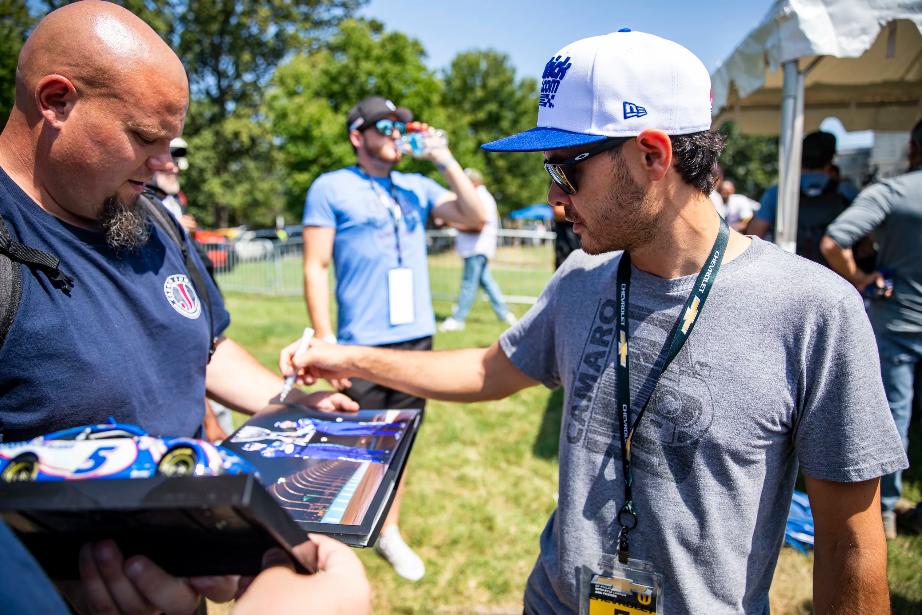 NASCAR Cup Series Champion Kyle Larson signs a fans photo and many other signatures during the Urban Youth Racing School event in front of the Please Touch Museum in Philadelphia on Friday.

