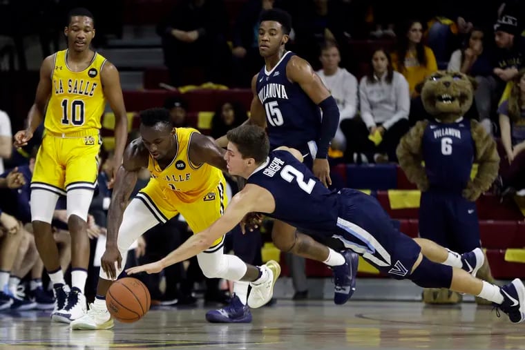 La Salle's David Beatty, left, and Villanova's Collin Gillespie chase after a loose ball during the first half of an NCAA college basketball game, Saturday, Dec. 1, 2018, in Philadelphia.