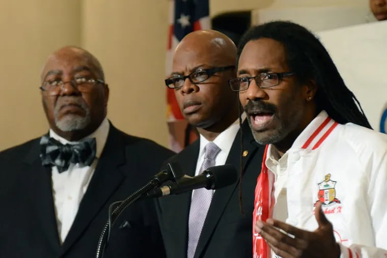 Michael Coard, a Cheyney University graduate and lawyer for a coalition suing the state, speaks at a rally in the Capitol Rotunda organized in an effort to press the state to help the financially struggling school, Tuesday, Nov. 10, 2015, in Harrisburg, Pa. Listening are state Reps. Curtis Thomas, left, and Stephen Kinsey.