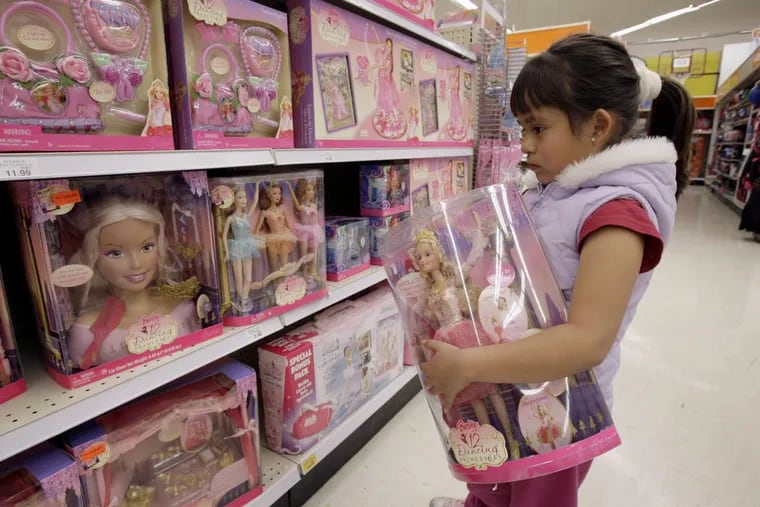 Yvette Ibarra holds a Dancing Princess Barbie doll while shopping at a Toys R us in Monrovia, Calif. Toys R Us CEO David Brandon told employees Wednesday,  that the company’s plan is to liquidate all of its U.S. stores.