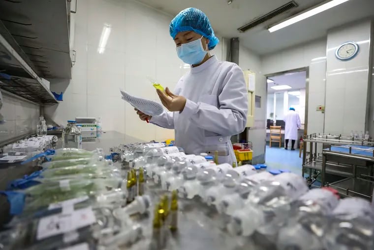 A nurse prepares medicine for coronavirus patients at Jinyintan Hospital in Wuhan, the epicenter of the outbreak, earlier this week. The respiratory illness has strained China's health-care system.