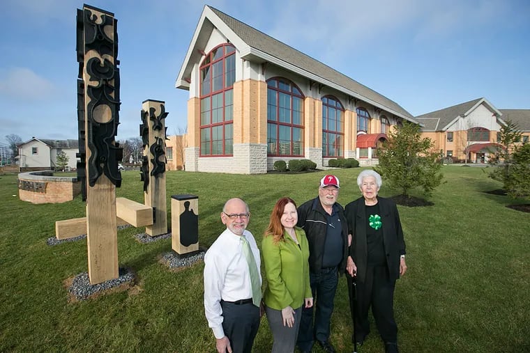 With the sculpture in place, Fred Adelson (from left), Laverne Mann, David Ascalon, and Sally Callaghan stand proud.