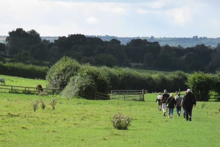 In the Cotswolds, a walking-tour group crosses pastures overlooking Adlestrop, memorialized in Jane Austen&#039;s &quot;Mansfield Park.&quot;