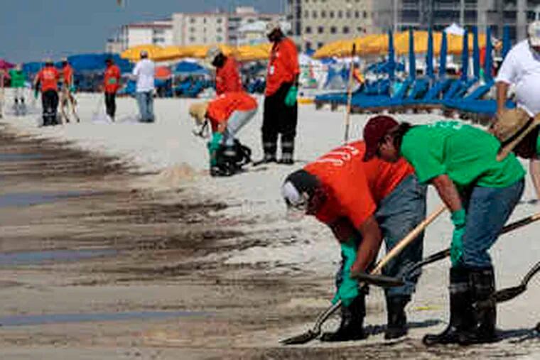 Workers clean the shore in Orange Beach, Ala. In Washington, the House is set to probe the April 20 explosion and its aftermath.
