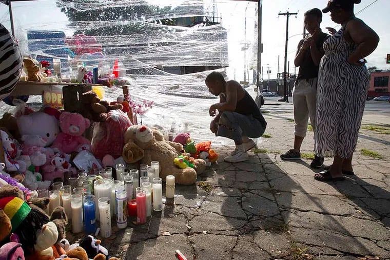 Richard Starchia, Tonia Jackson , and her daughter Riconya (right) visit a memorial to the three children killed during the carjacking. Their mother, Keisha Williams, has also died, officials said. ALEJANDRO A. ALVAREZ / Staff Photographer/File