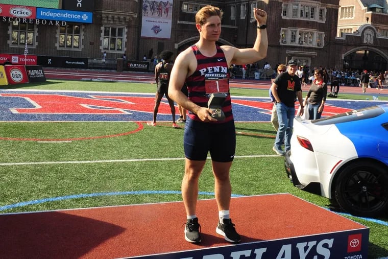University of Pennsylvania (Penn) Quakers javelin thrower Marc Minichello celebrates with his Penn Relays watch after winning the men's javelin competition at Franklin Field in Philadelphia on April 30, 2022.