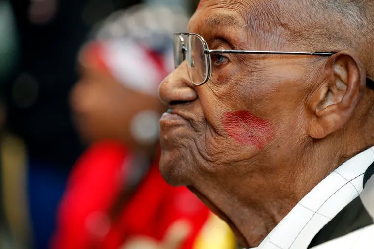 Lawrence Brooks sported a lipstick kiss on his cheek, planted by a member of the singing group Victory Belles, as he celebrated his 110th birthday at the National World War II Museum in New Orleans on Sept. 12, 2019.