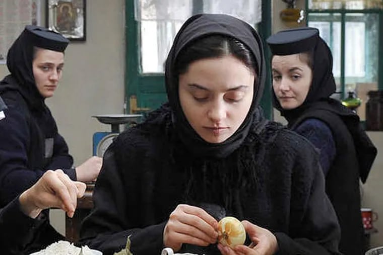 Cosmina Stratan (center) plays Voichita, one of the devout nuns in a monastery perched atop rugged land in &quot;Beyond the Hills.&quot;