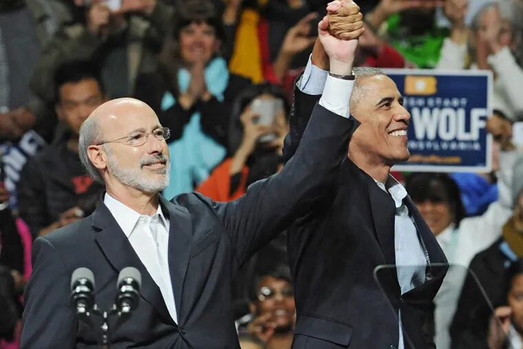 President Obama and Tom Wolf, Democratic candidate for governor of Pennsylvania, respond to the cheers of the crowd at rally at Temple University Nov. 2, 2014.  ( CLEM MURRAY / Staff Photographer )