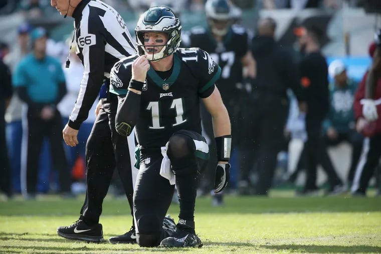 Eagles quarterback Carson Wentz (11) gets up after being sacked during a game against the New York Giants at Lincoln Financial Field in South Philadelphia on Sunday, Nov. 25, 2018. The Eagles won 25-22. TIM TAI / Staff Photographer