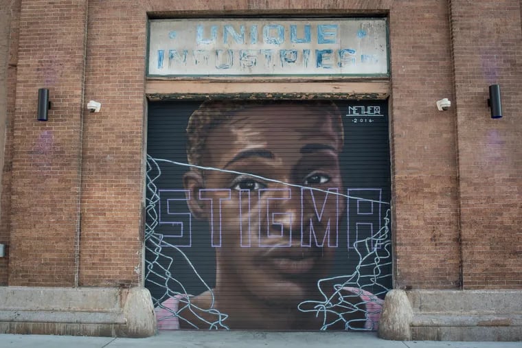 A striking image of a young black person with the word "STIGMA" written across his face lies on the side of the Fillmore music venue in Philadelphia's Fishtown neighborhood. The art piece is the work created by a Baltimore street artist named Nether. MICHAEL Ares / Staff Photographer DIGITAL